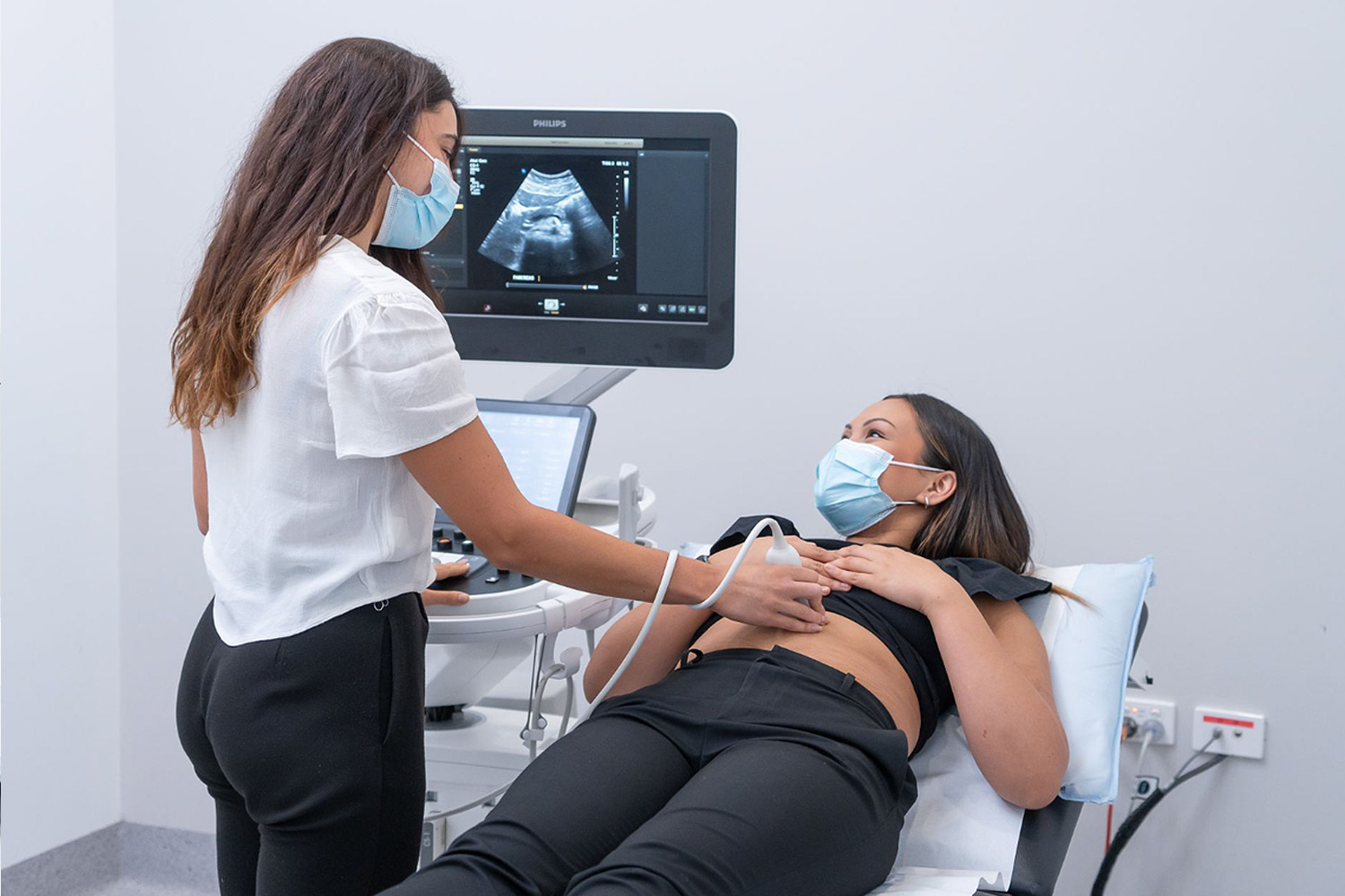 Female Patient Undergoing Ultrasound Procedure | Ultrasound Australia | FMIG